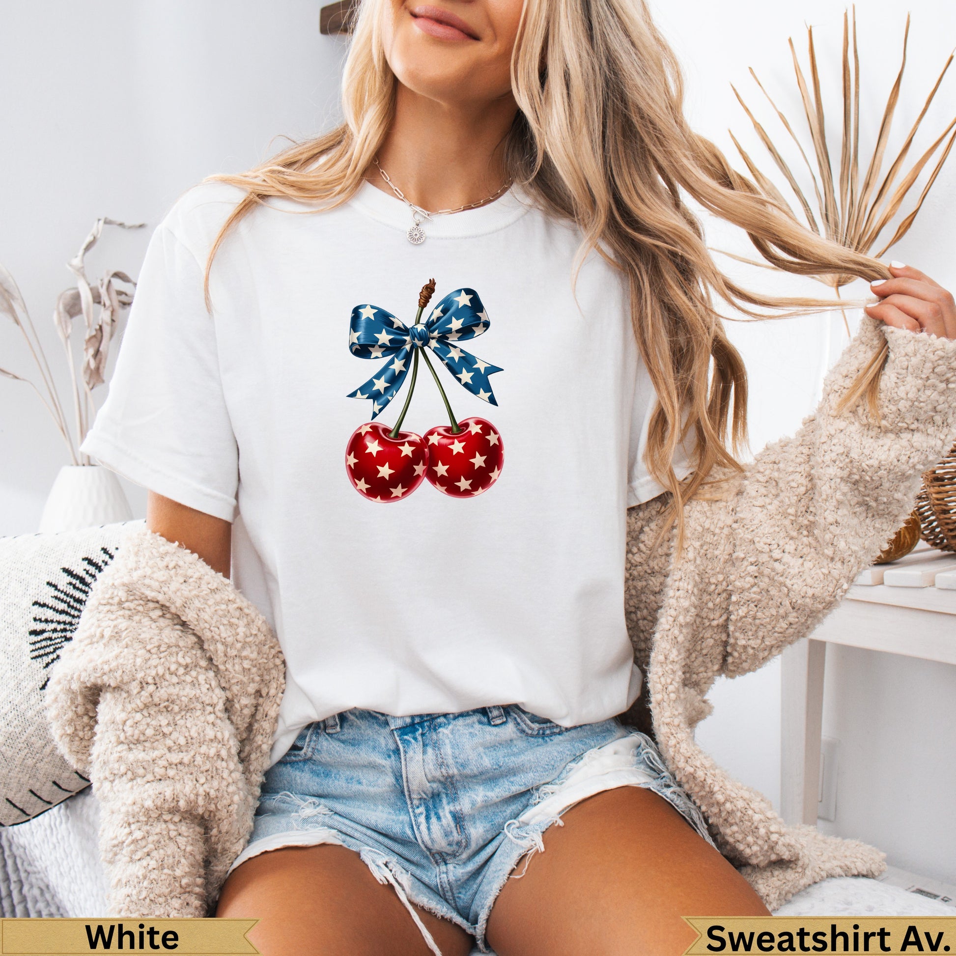 White t-shirt with two red cherries tied with a blue and white ribbon.