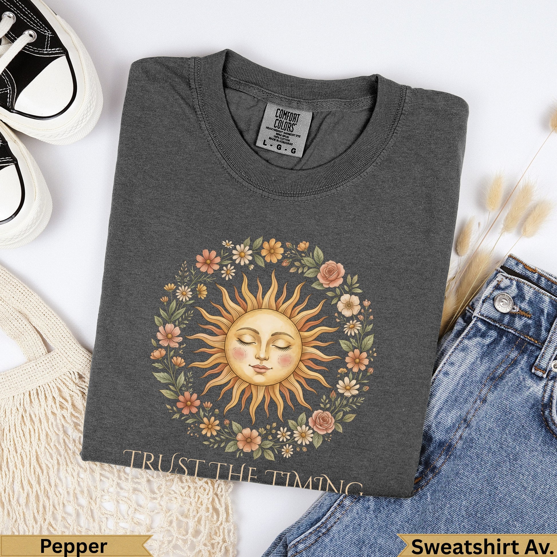 Dark gray t-shirt with a sun and floral wreath graphic and "TRUST THE TIMING" text.