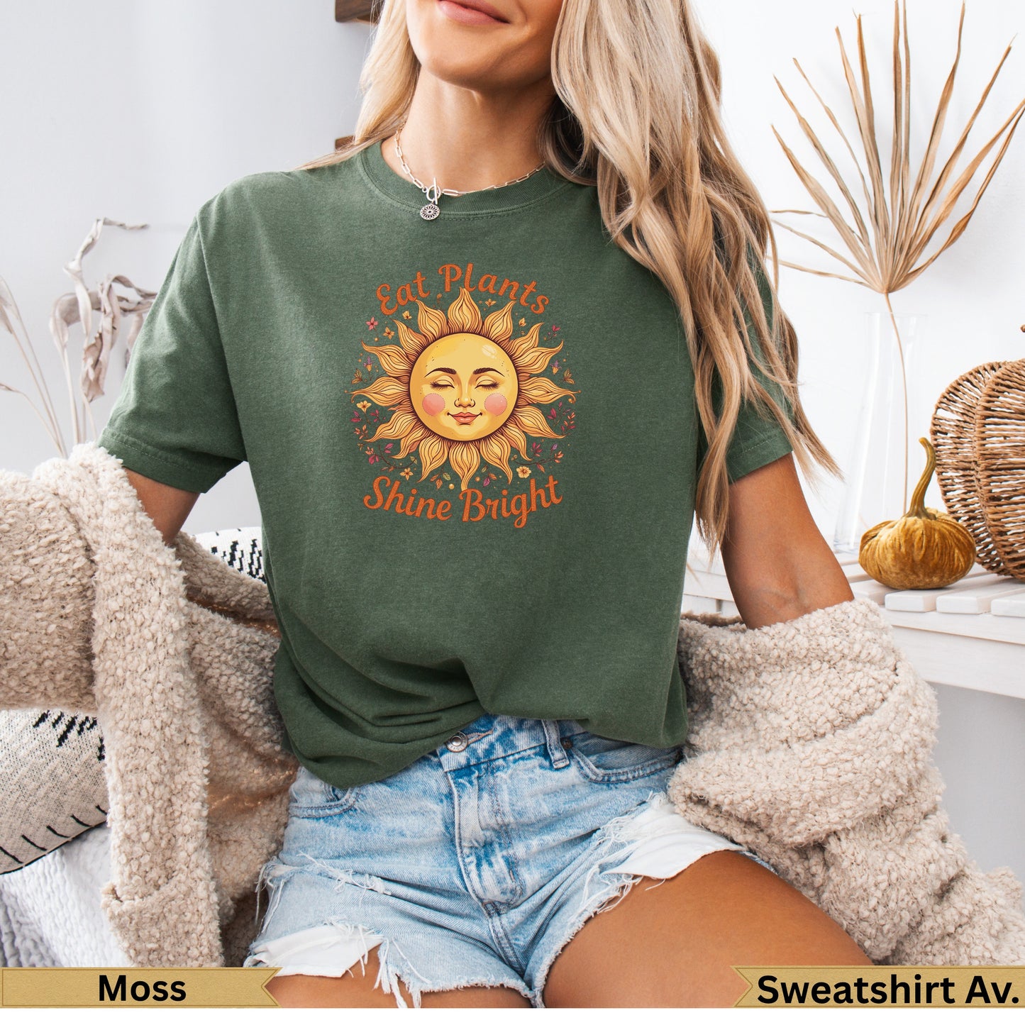 Green t-shirt with sun graphic and "Eat Plants Shine Bright" text.