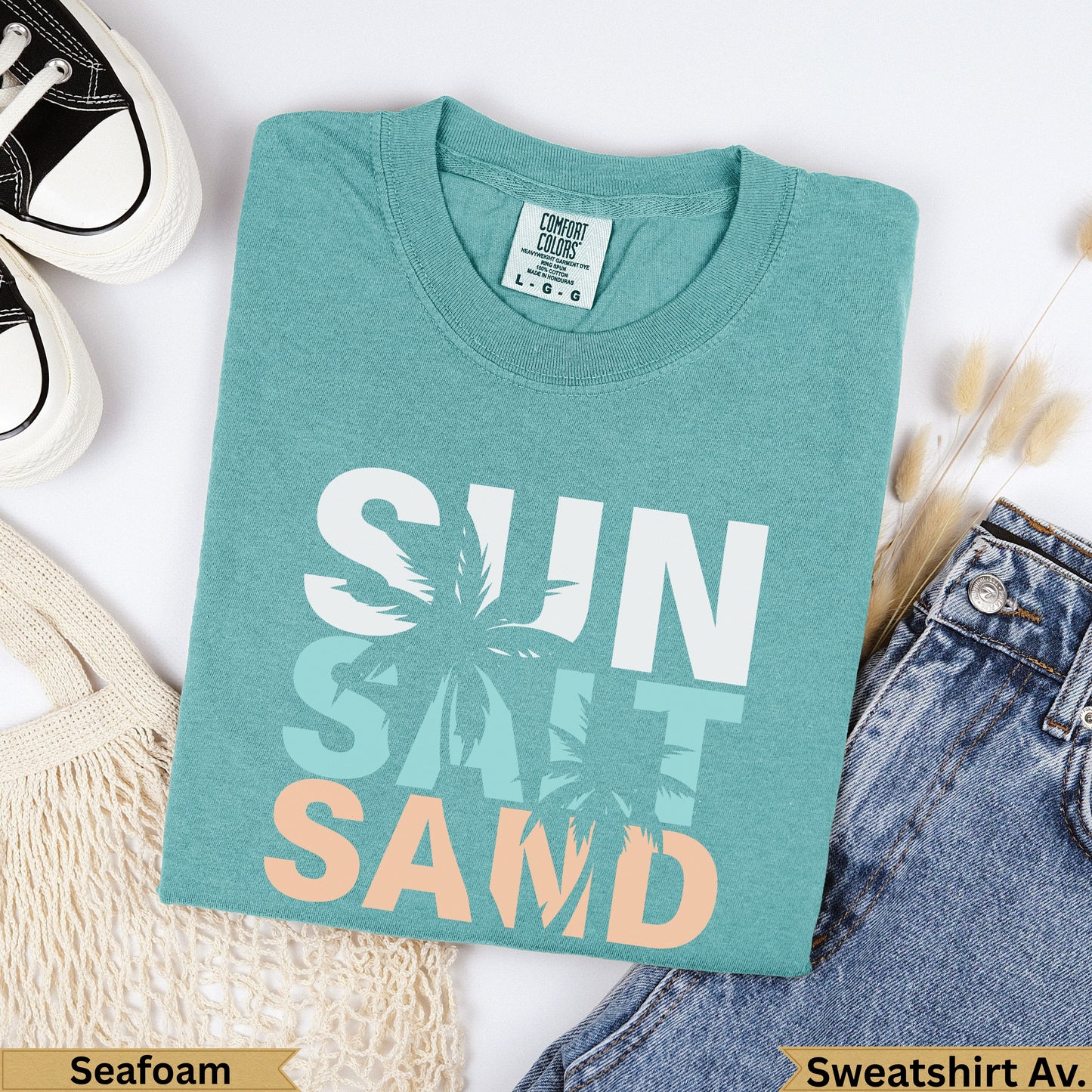 Teal sweatshirt with "SUN SALT SAND" text and palm tree graphics.