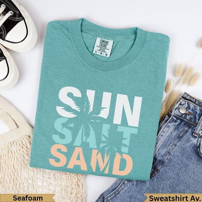 Teal sweatshirt with "SUN SALT SAND" text and palm tree graphics.