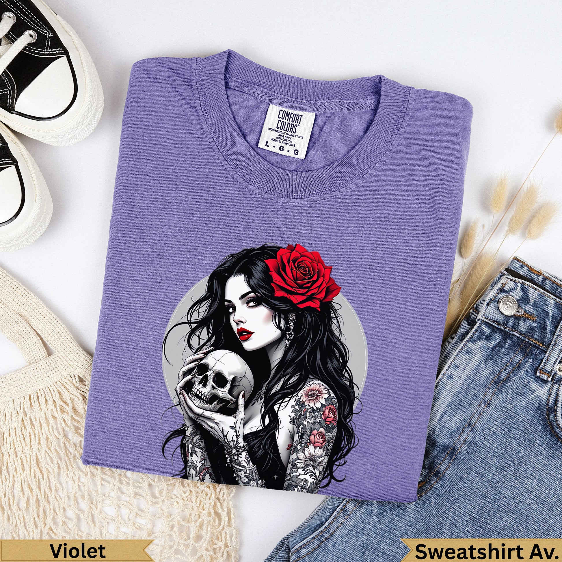 Purple Comfort Colors sweatshirt with tattooed woman holding a skull and a red rose.