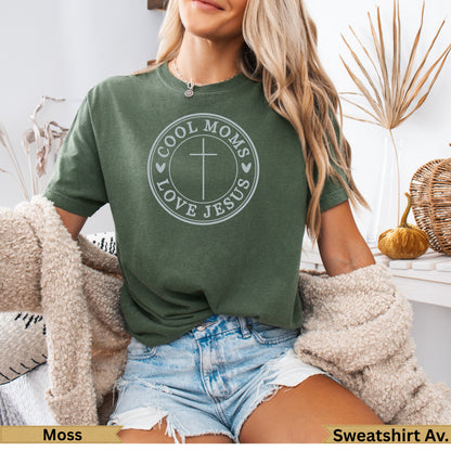 Green t-shirt with "Cool Moms Love Jesus" text and cross graphic.