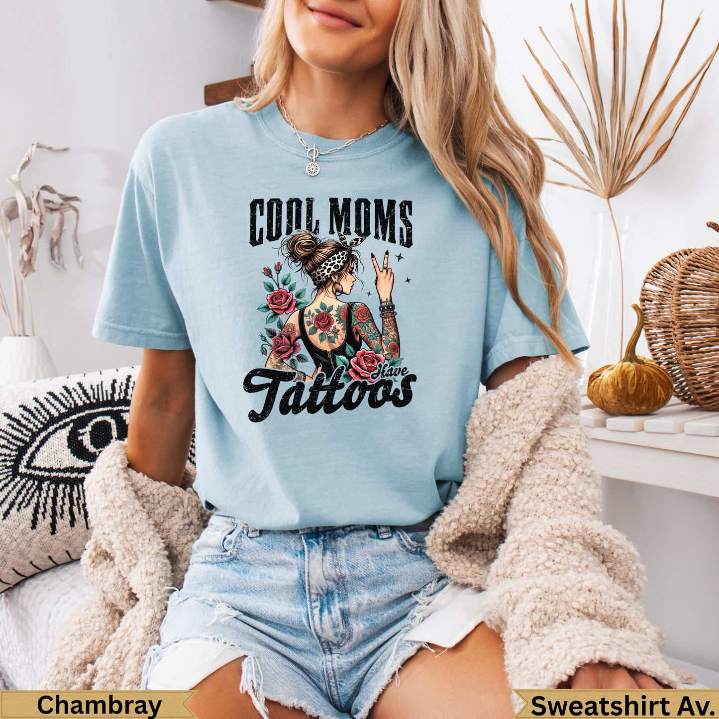 Light blue graphic t-shirt with "Cool Moms Have Tattoos" text and floral design.
