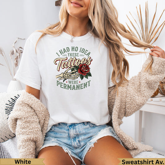 White sweatshirt with "I had no idea tattoos were permanent" text and rose design.