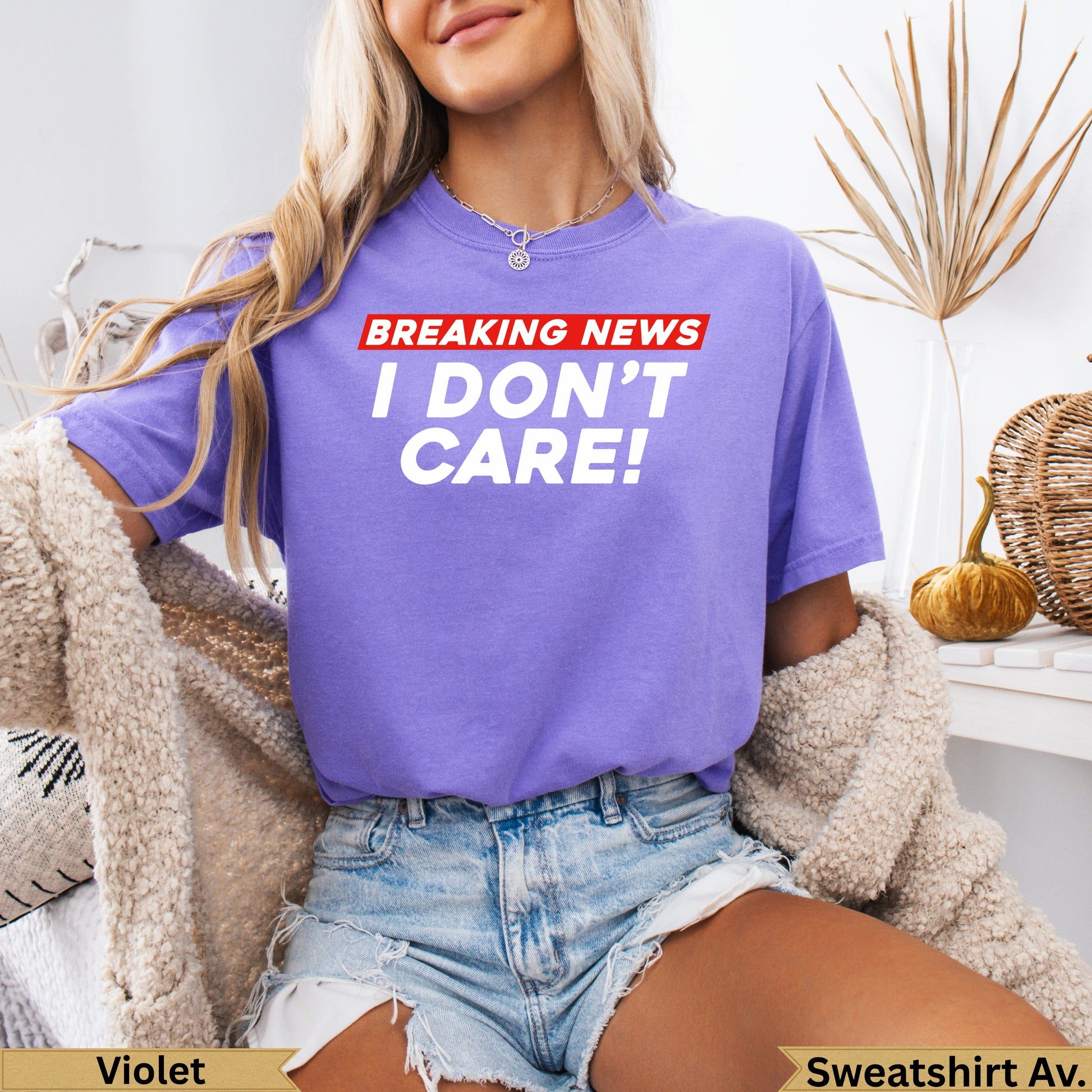 Purple t-shirt with "BREAKING NEWS I DON'T CARE!" text.