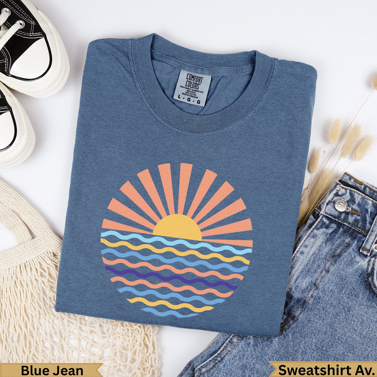 Blue Jean Comfort Colors sweatshirt with sun and waves graphic.
