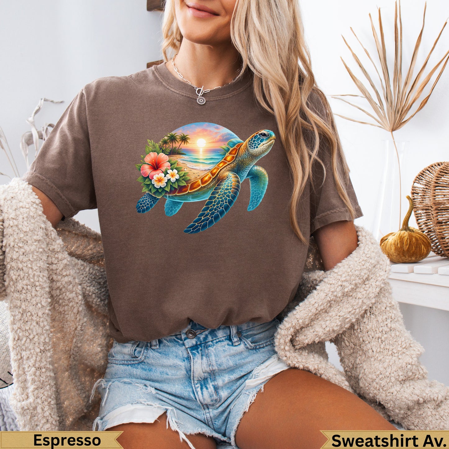 Brown t-shirt featuring a colorful sea turtle against a beach sunset scene.