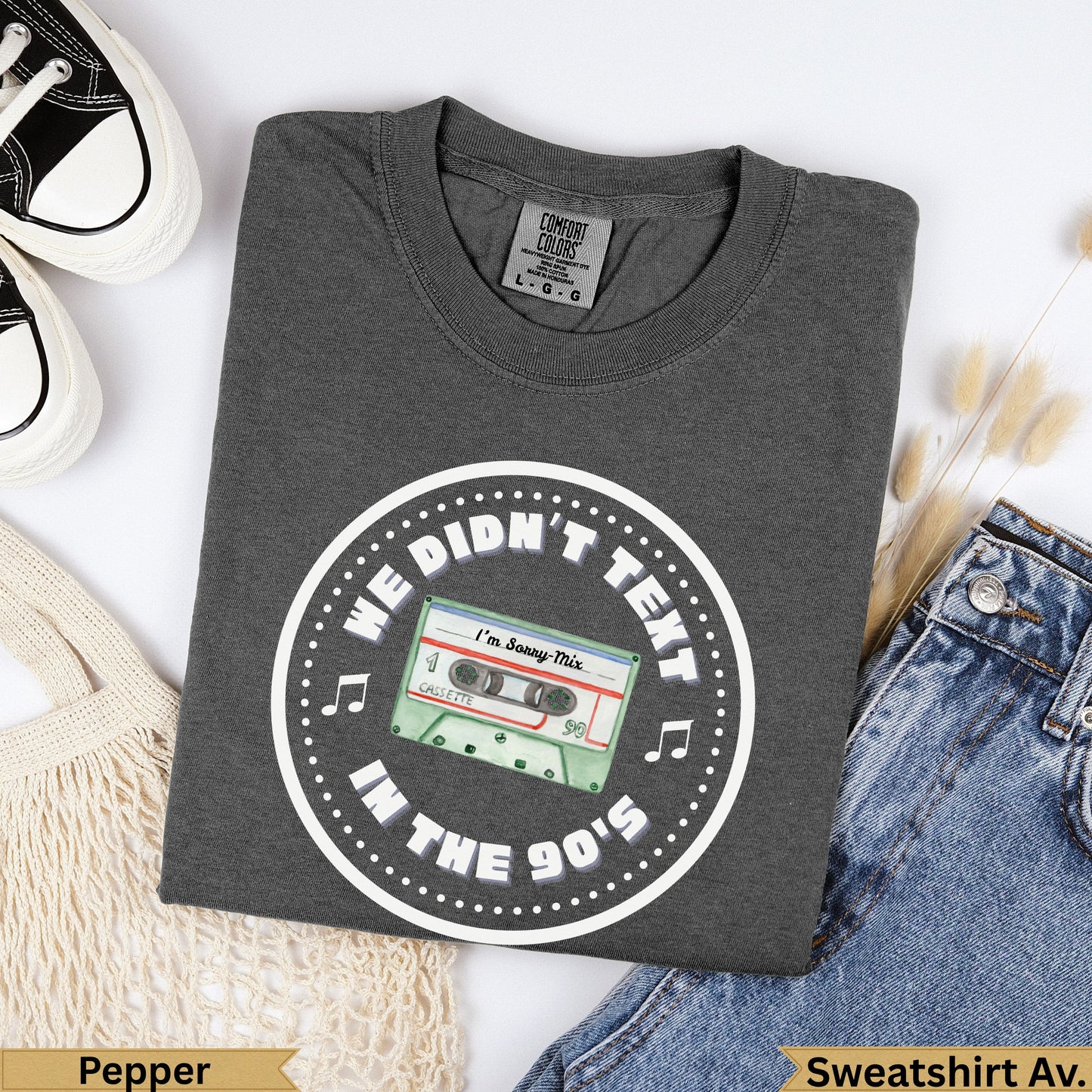 Dark grey t-shirt with "We Didn't Text In The 90's" and cassette graphic.