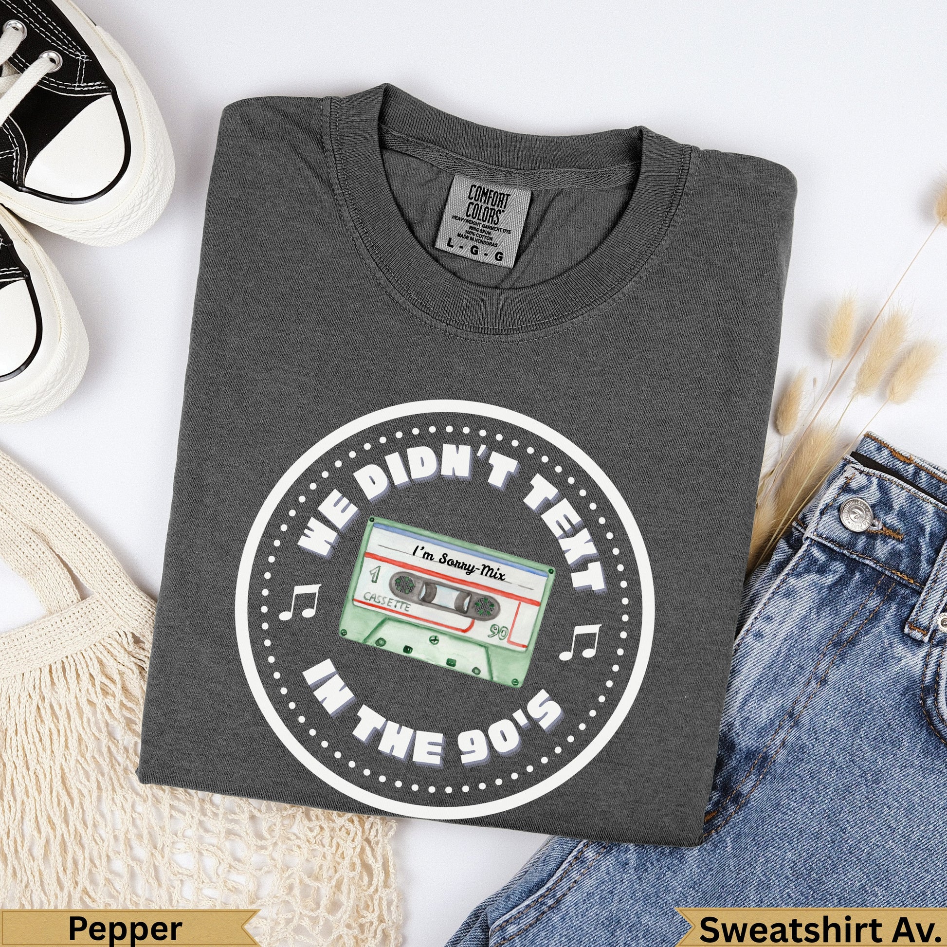 Dark grey t-shirt with "We Didn't Text In The 90's" and cassette graphic.