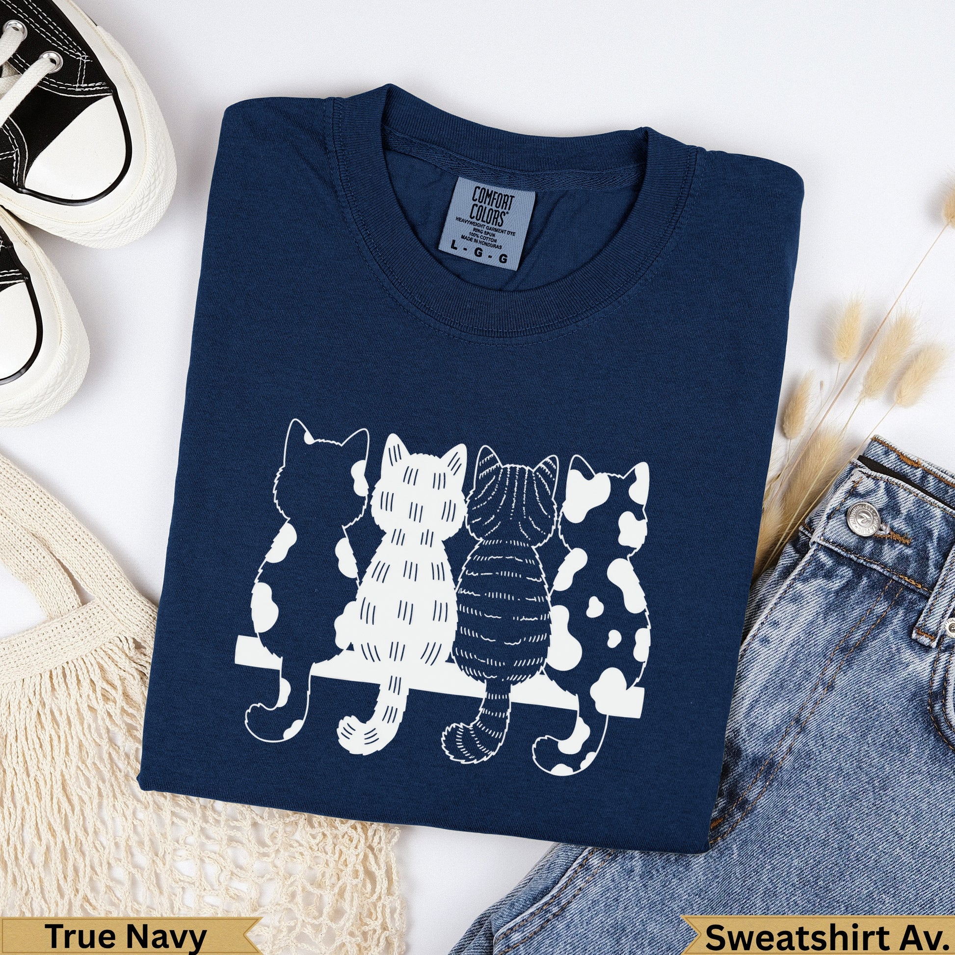Navy sweatshirt with four white cat silhouettes across the chest.