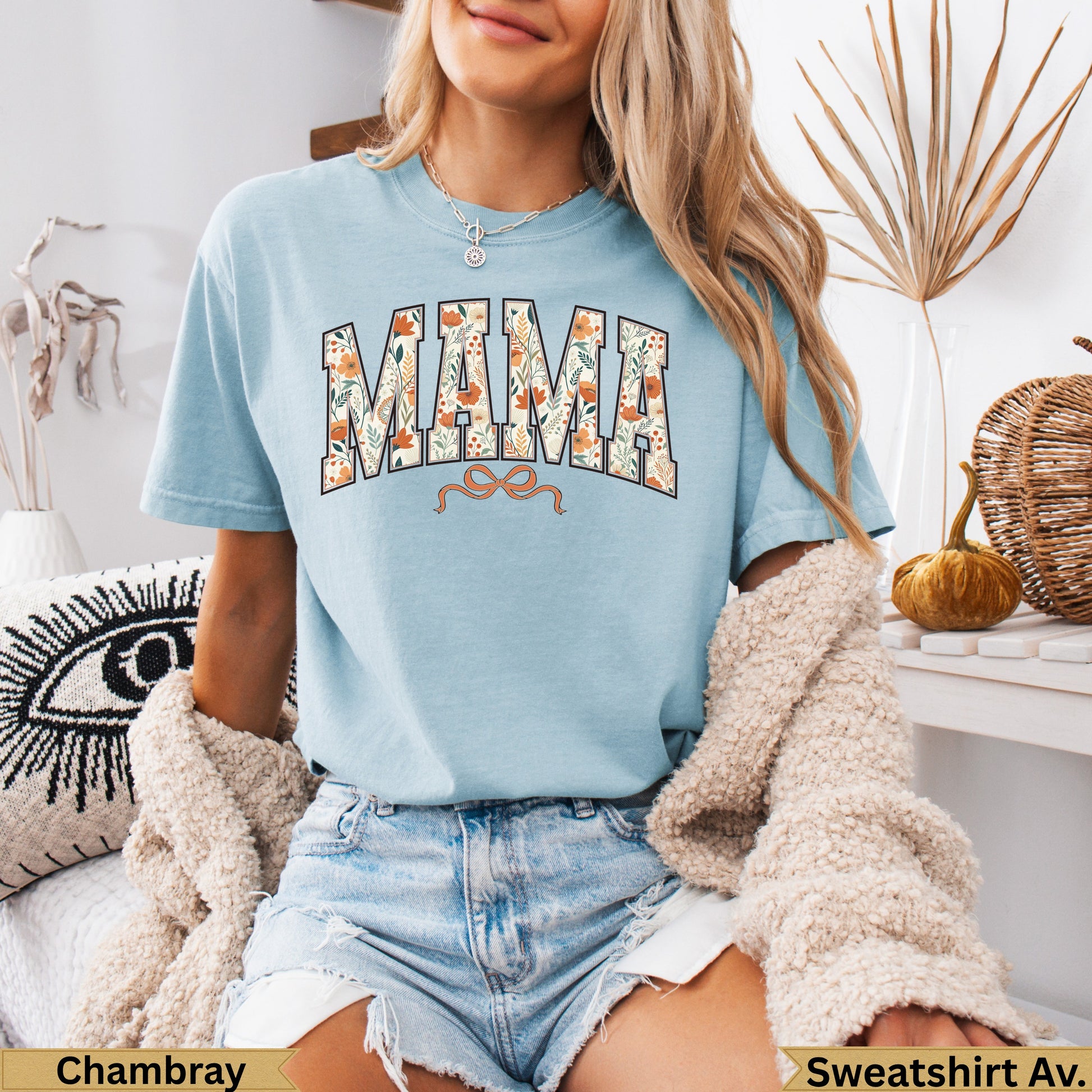 Light blue t-shirt with floral "MAMA" text and orange bow detail.