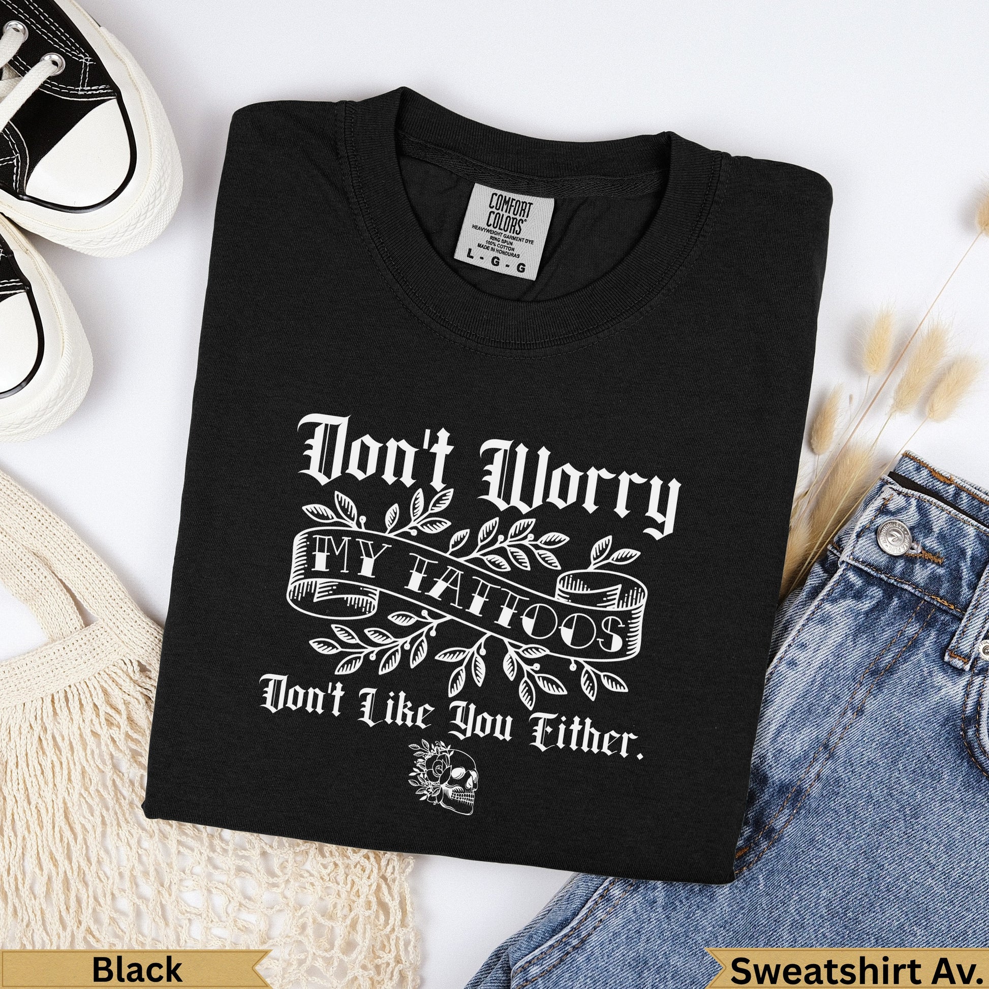 Black t-shirt with "Don't Worry My Tattoos Don't Like You Either" text and skull.