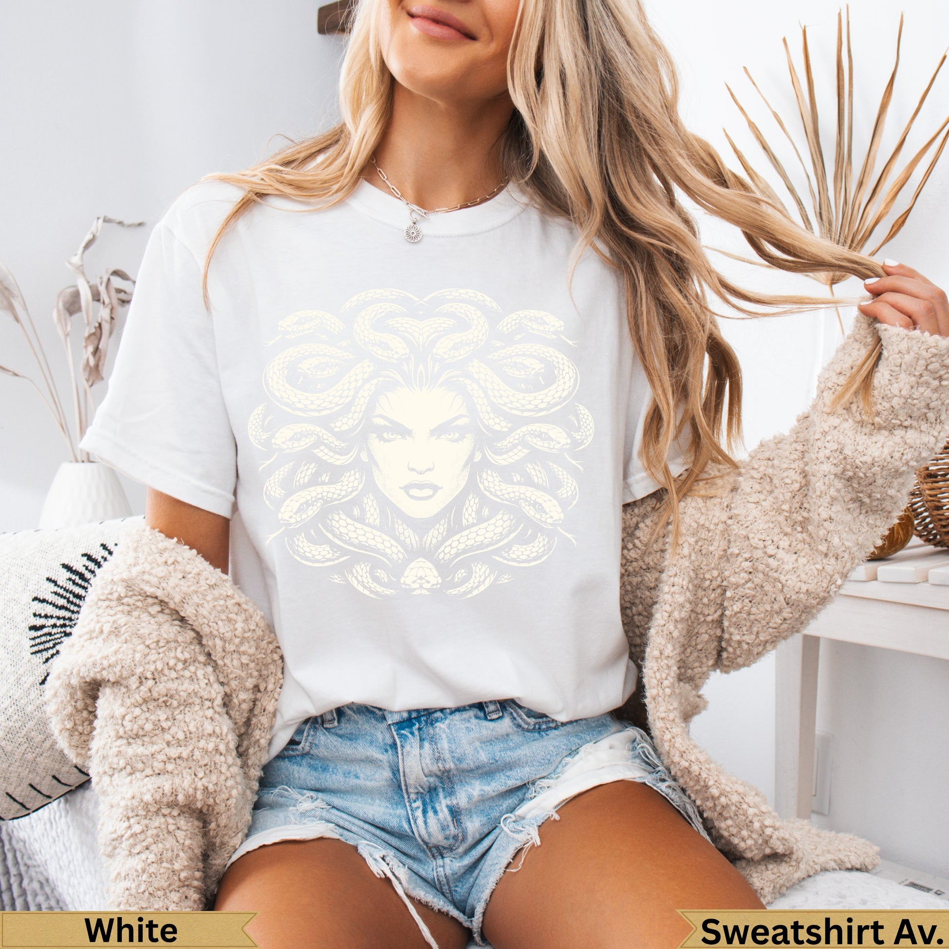 White t-shirt with a Medusa graphic and text "Sweatshirt Av."