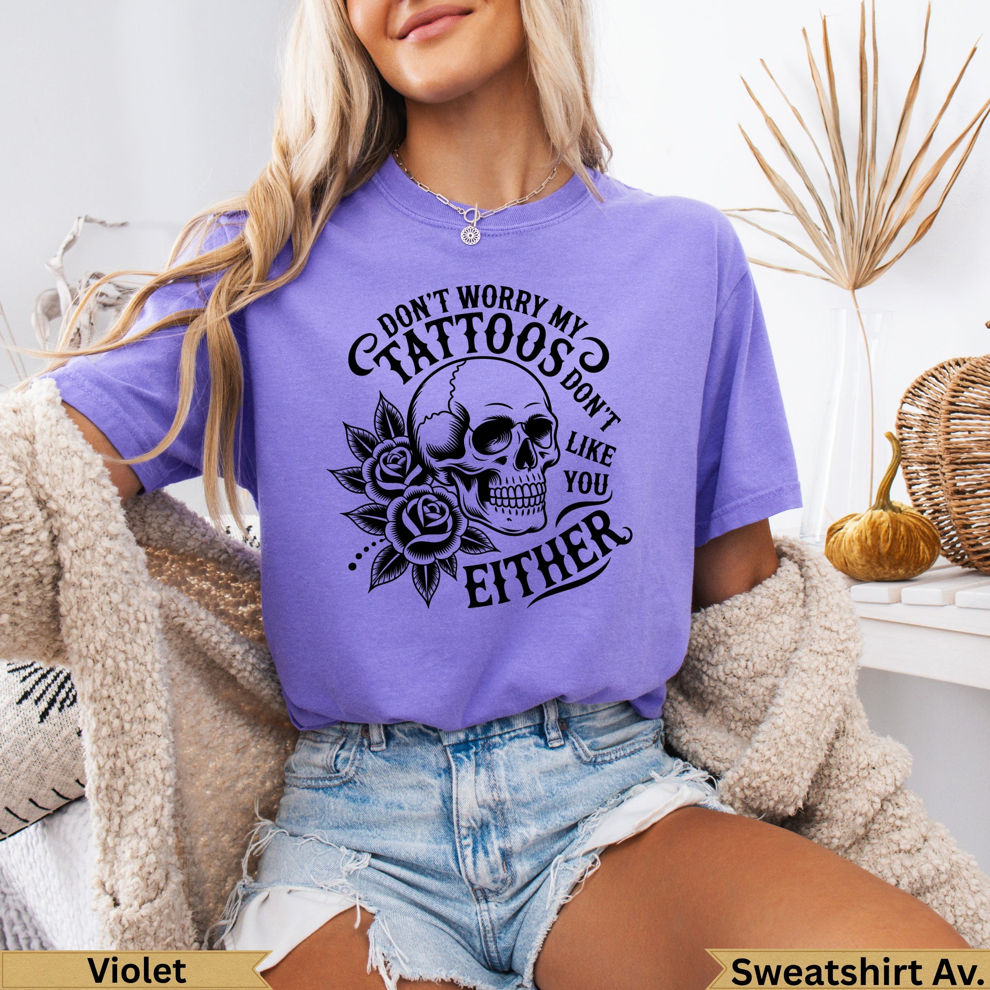 Purple t-shirt with skull and roses graphic, "Don't worry my tattoos don't like you either".