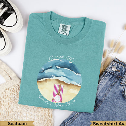 Seafoam Comfort Colors sweatshirt with "Catch Me Under the Sun" beach graphic.