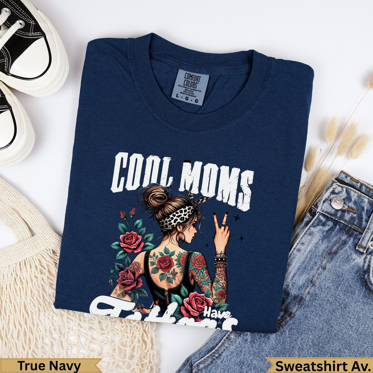 Navy crewneck sweatshirt with "COOL MOMS Have" text and tattooed woman graphic.