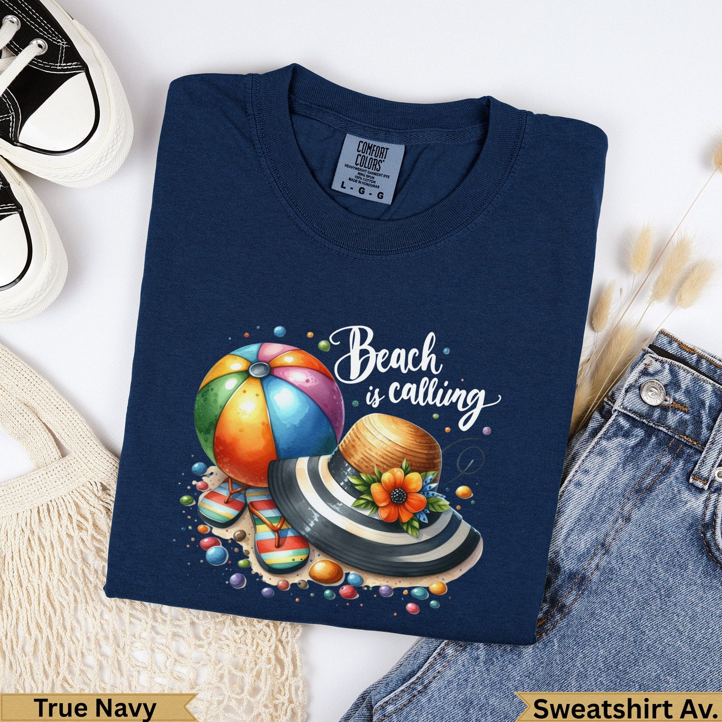 Navy t-shirt with "Beach is calling" graphic featuring a beach ball and hat.