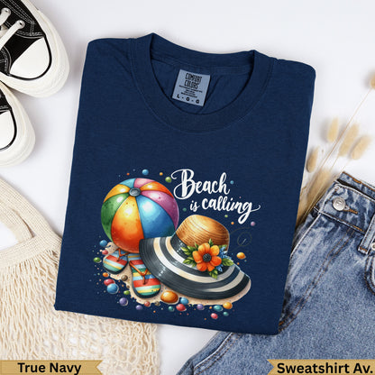 Navy t-shirt with "Beach is calling" graphic featuring a beach ball and hat.