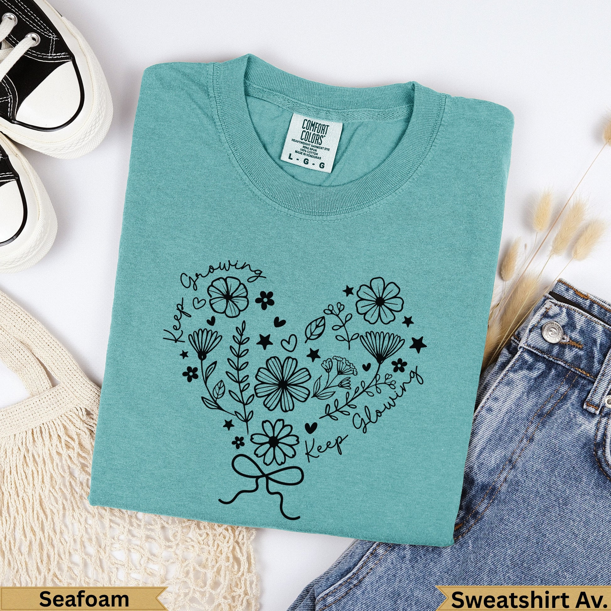 Teal Comfort Colors sweatshirt with black floral heart design and "Keep Growing, Keep Glowing" text.
