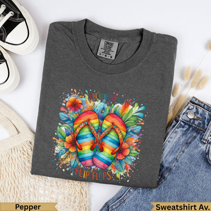 Dark grey t-shirt with rainbow flip-flops and flowers graphic.