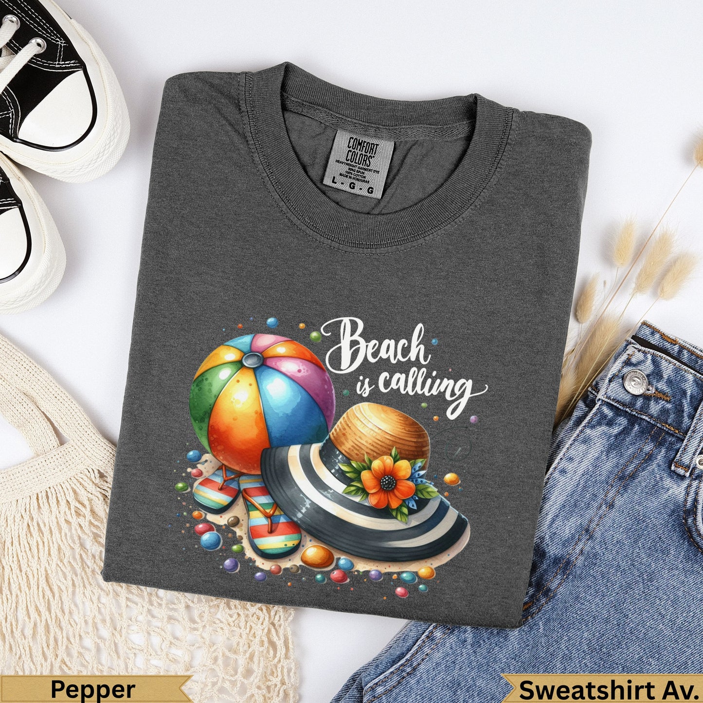 Dark grey t-shirt with Beach is calling graphic, hat, and flip-flops.