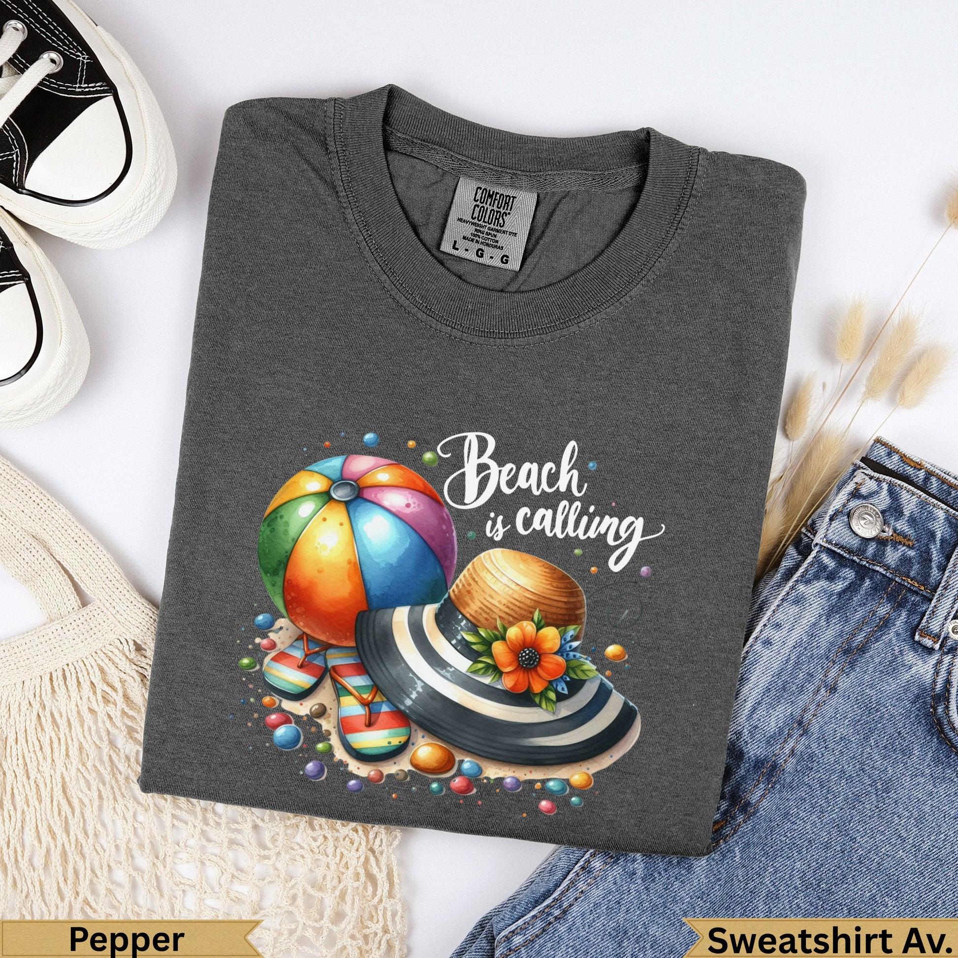 Dark grey t-shirt with Beach is calling graphic, hat, and flip-flops.