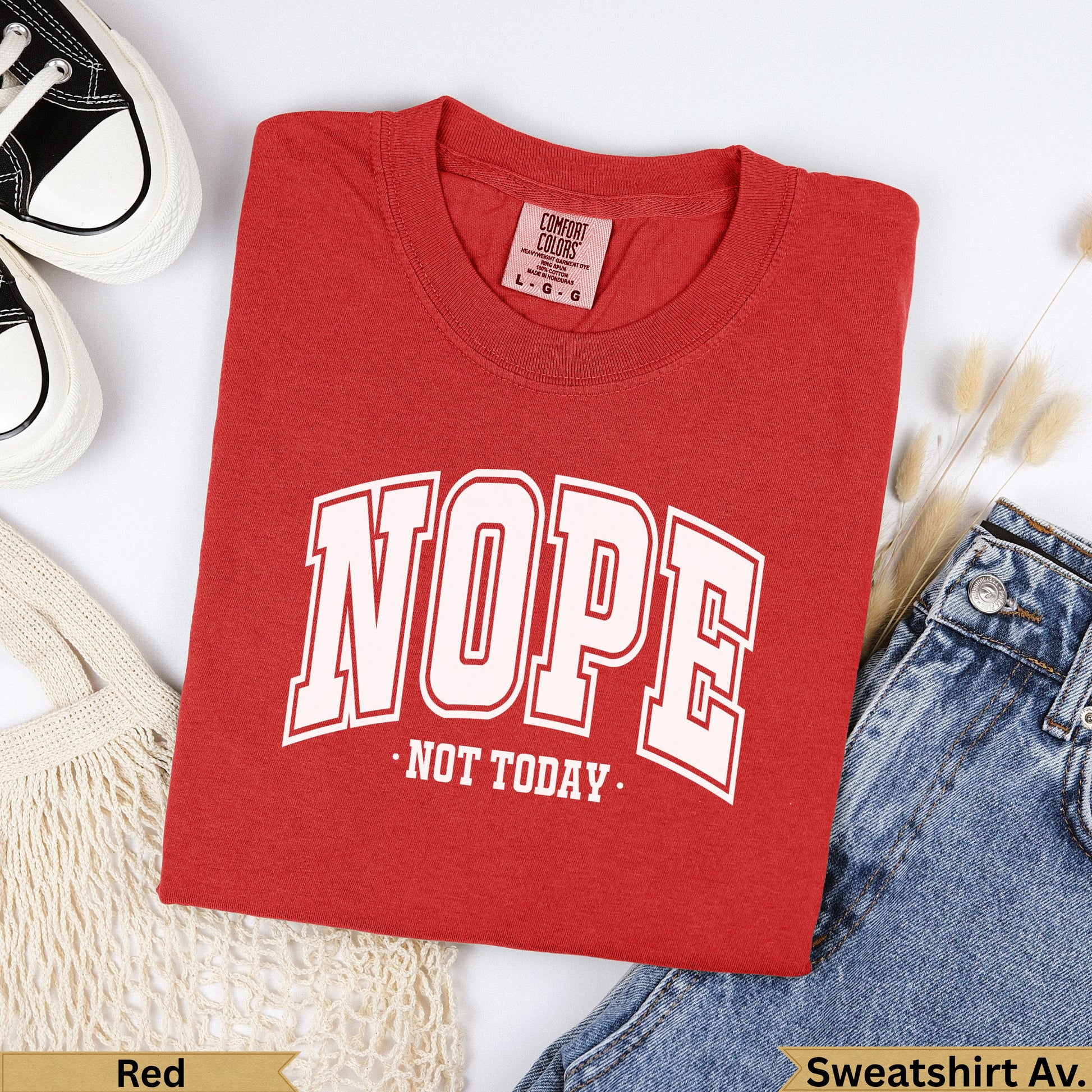 Red crewneck t-shirt with "NOPE NOT TODAY" graphic, laid flat with jeans.