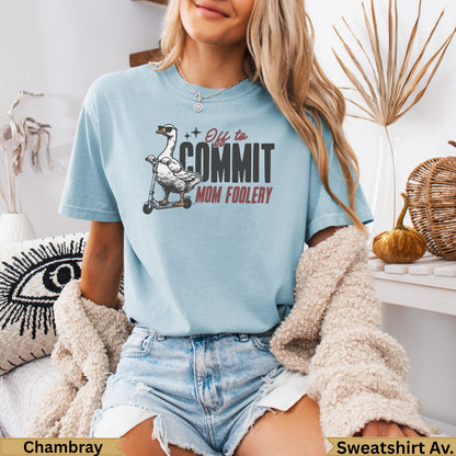 Light blue t-shirt with a goose on a scooter and the text "Off to Commit Mom Foolery".