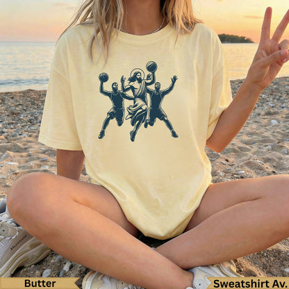 Jesus playing basketball with two people, wearing a butter-colored t-shirt.