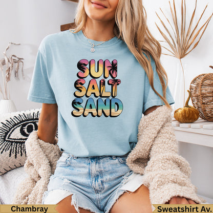 Light blue t-shirt with "Sun Salt Sand" and palm tree graphic.