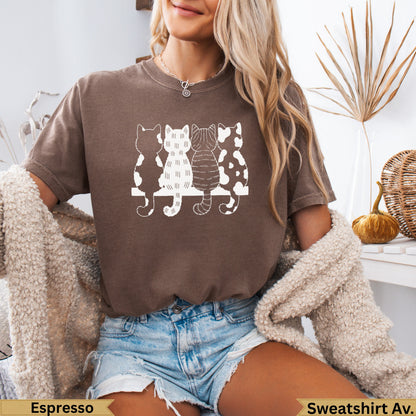 Three cats silhouetted on a white bench, wearing an Espresso sweatshirt.