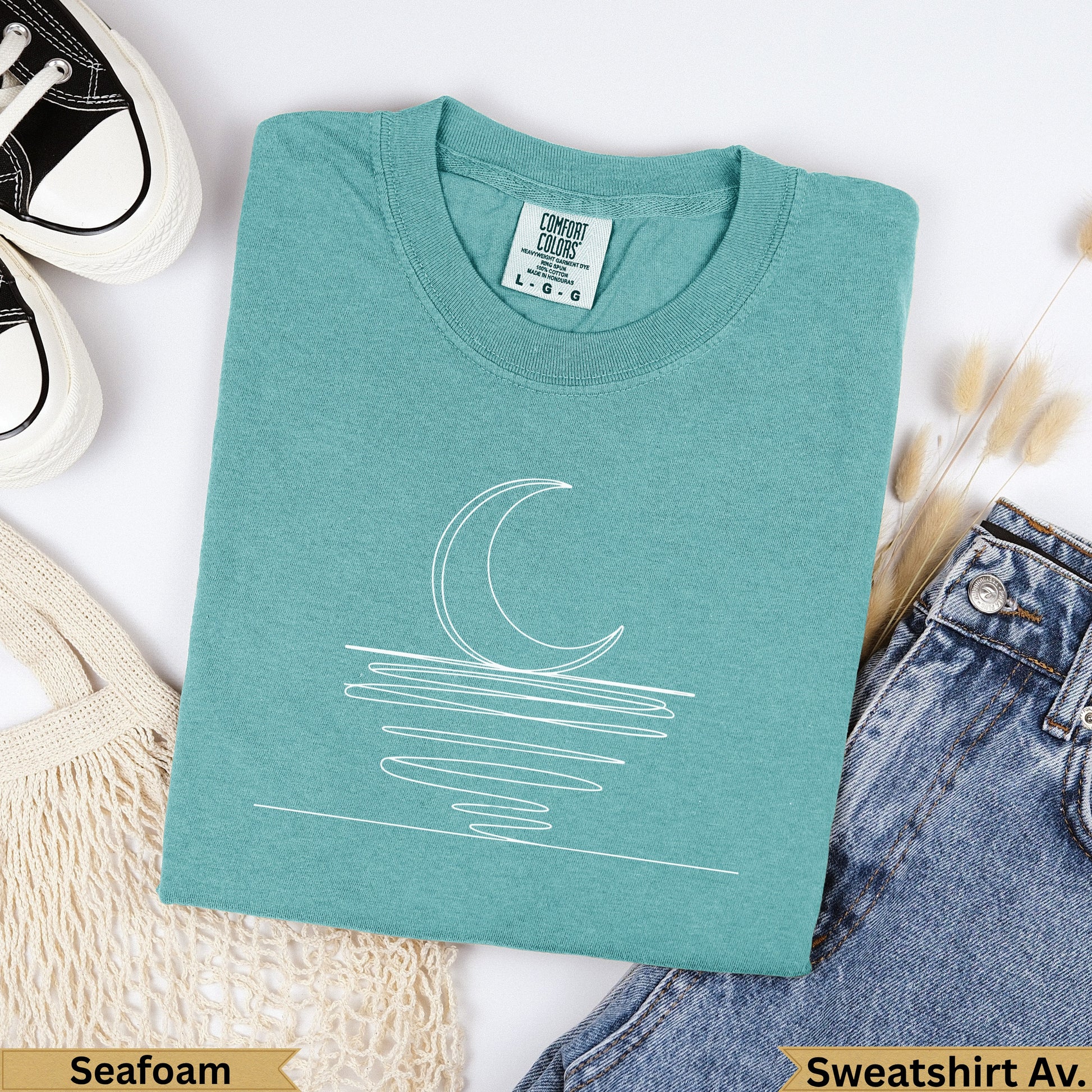 Teal Comfort Colors sweatshirt with white crescent moon line art, "Seafoam" text.