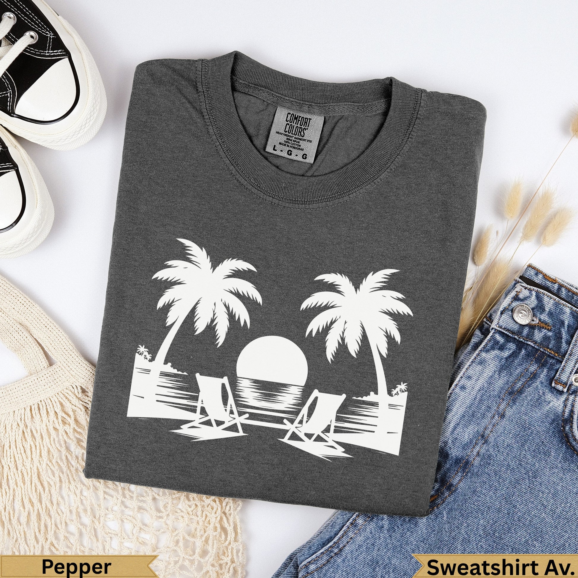 Dark grey t-shirt with white palm trees, beach chairs, and ocean graphic.