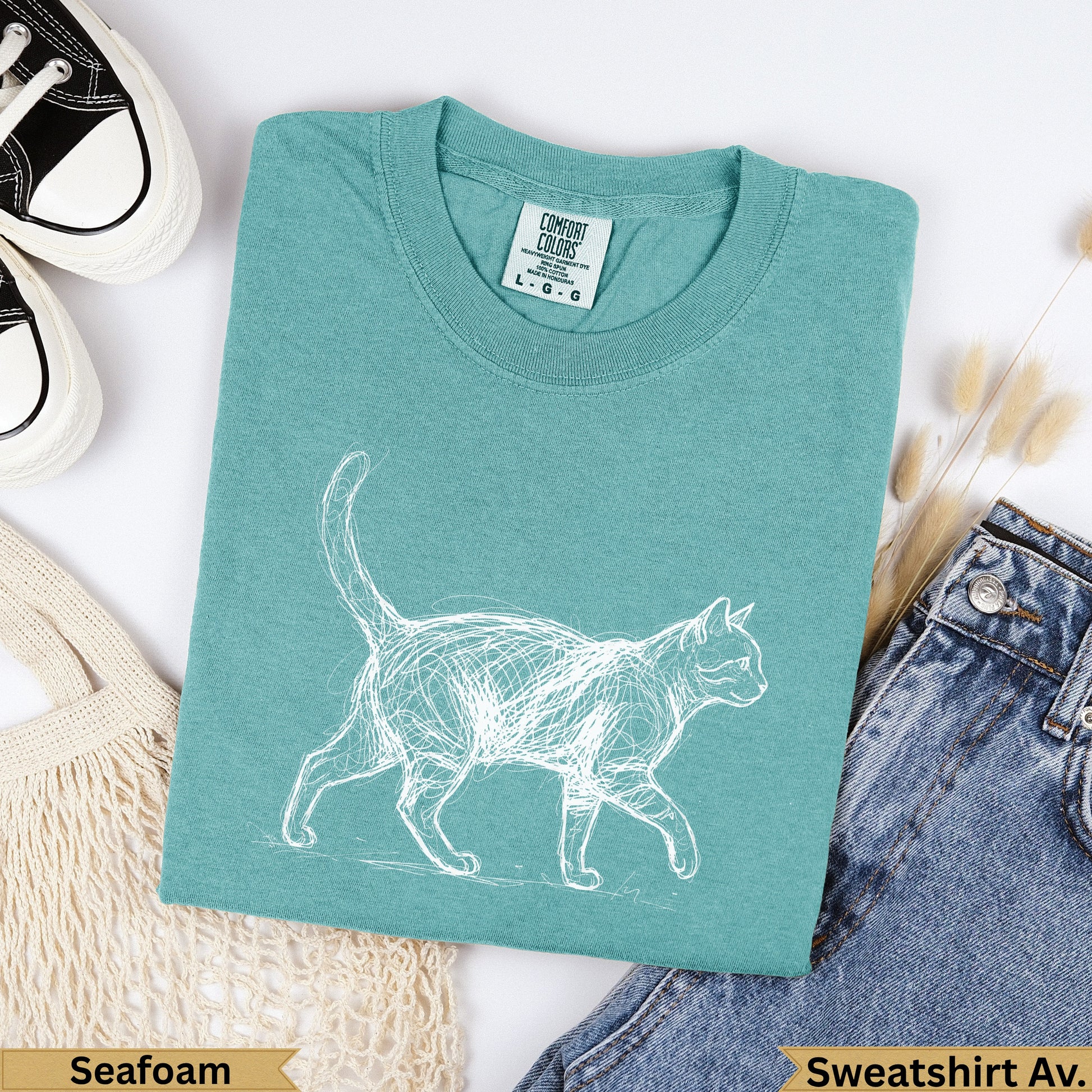Teal t-shirt with a white sketch of a cat, "Seafoam" and "Sweatshirt Av." labels.