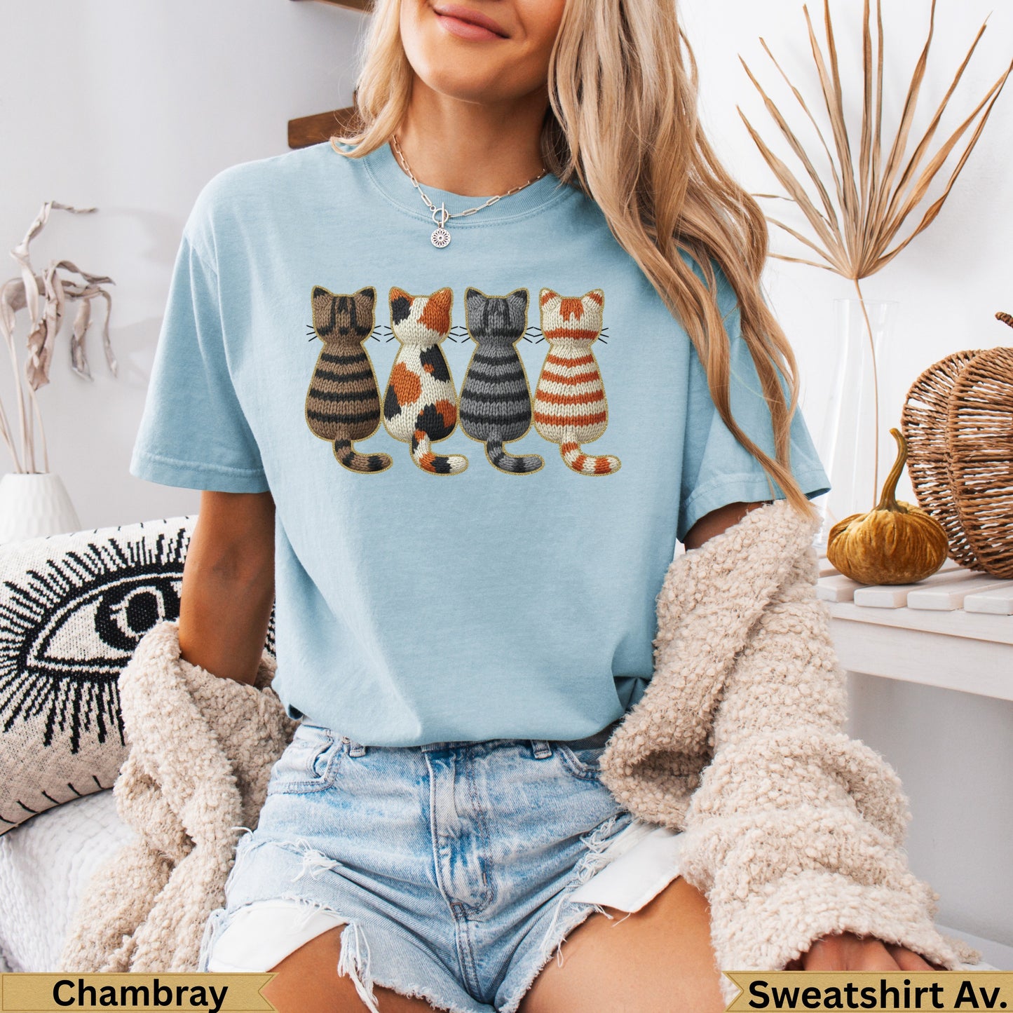 Light blue t-shirt with embroidered cats and "Chambray" and "Sweatshirt Av." text.