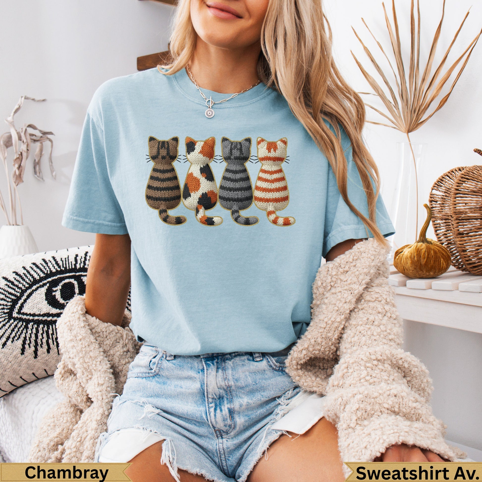 Light blue t-shirt with embroidered cats and "Chambray" and "Sweatshirt Av." text.