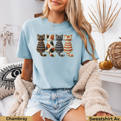 Light blue t-shirt with embroidered cats and "Chambray" and "Sweatshirt Av." text.