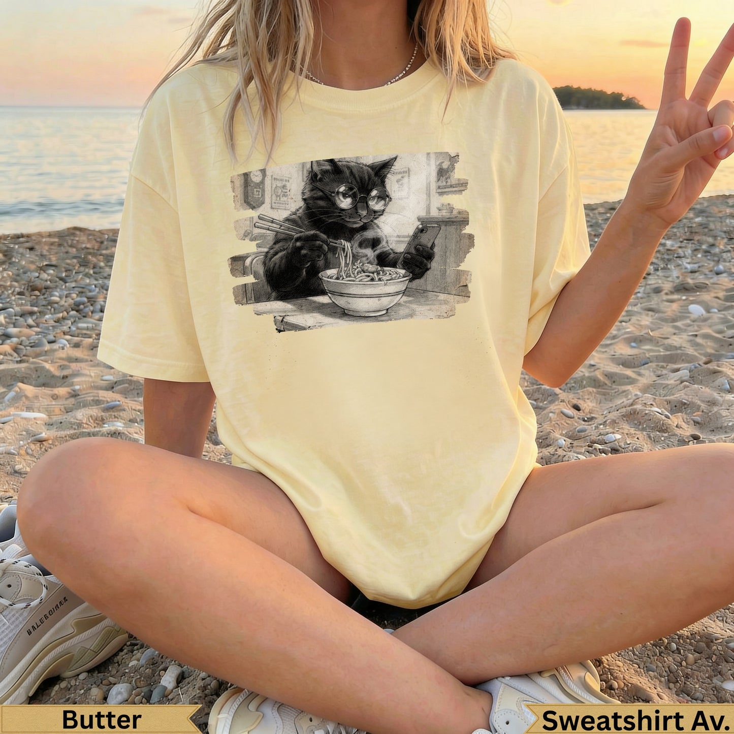 Light yellow t-shirt with black cat wearing glasses eating noodles graphic.