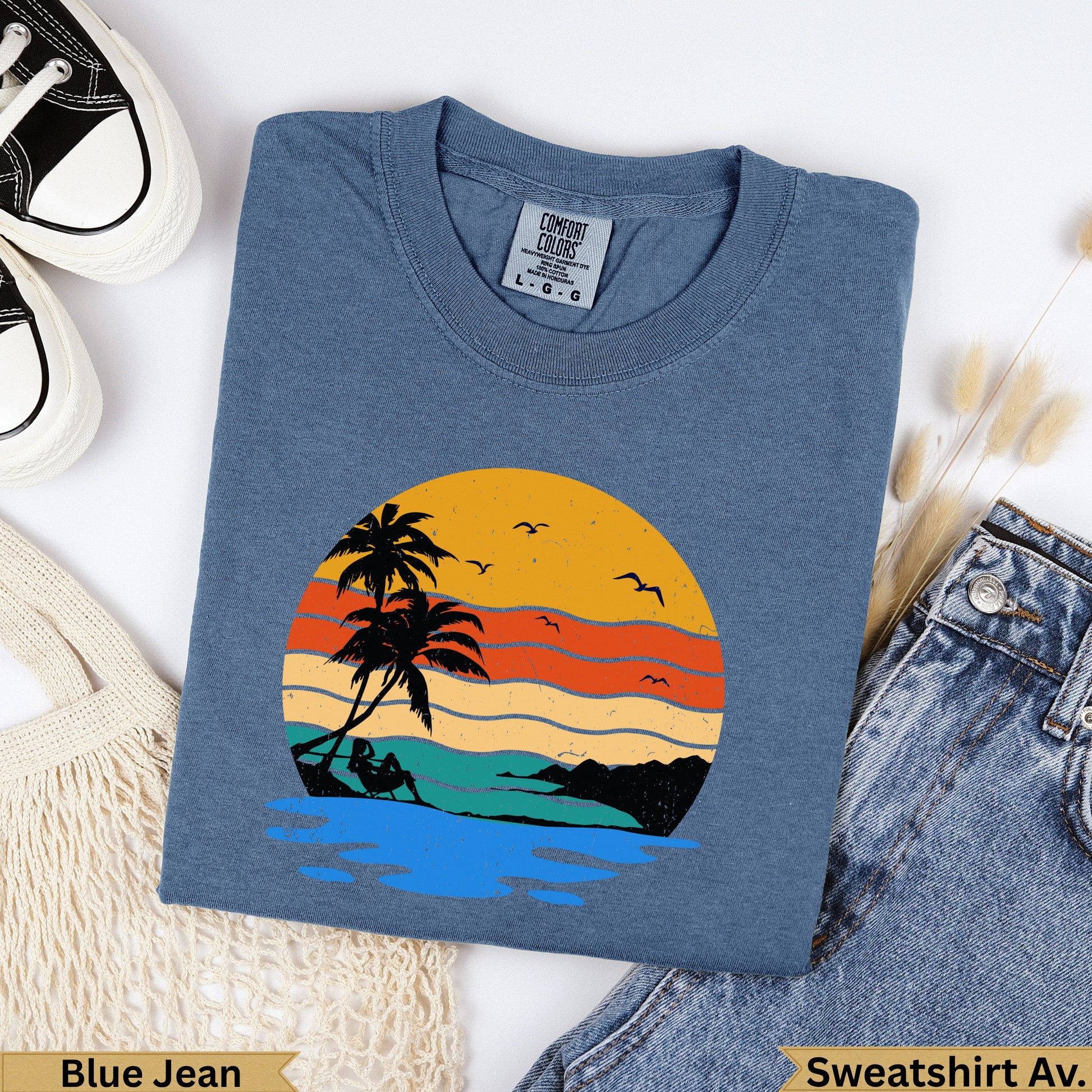 Blue Jean Comfort Colors sweatshirt with sunset beach graphic.