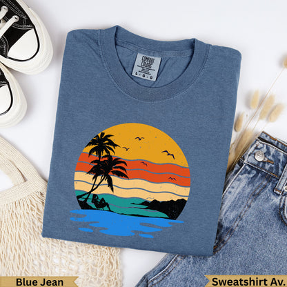 Blue Jean Comfort Colors sweatshirt with sunset beach graphic.