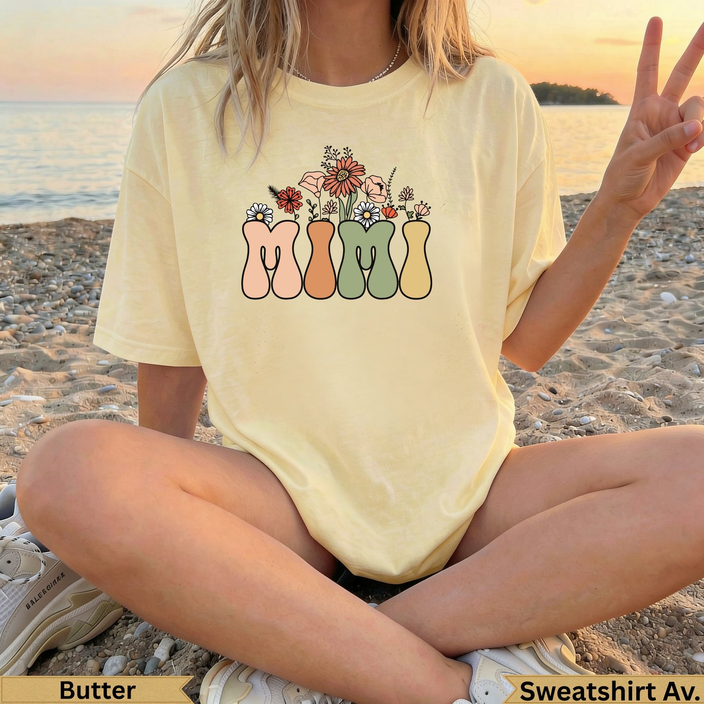 Yellow graphic t-shirt with "MIMI" in floral vases on a beach.