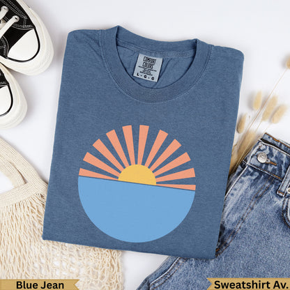 Blue Jean Comfort Colors sweatshirt with a stylized sun over water graphic.