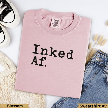Pink Comfort Colors t-shirt with "Inked Af." text, shown with jeans.