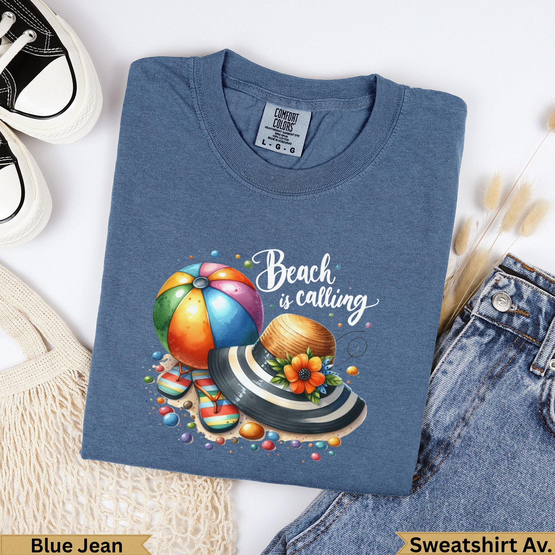 Blue Jean sweatshirt with "Beach is Calling" graphic featuring a beach ball and hat.