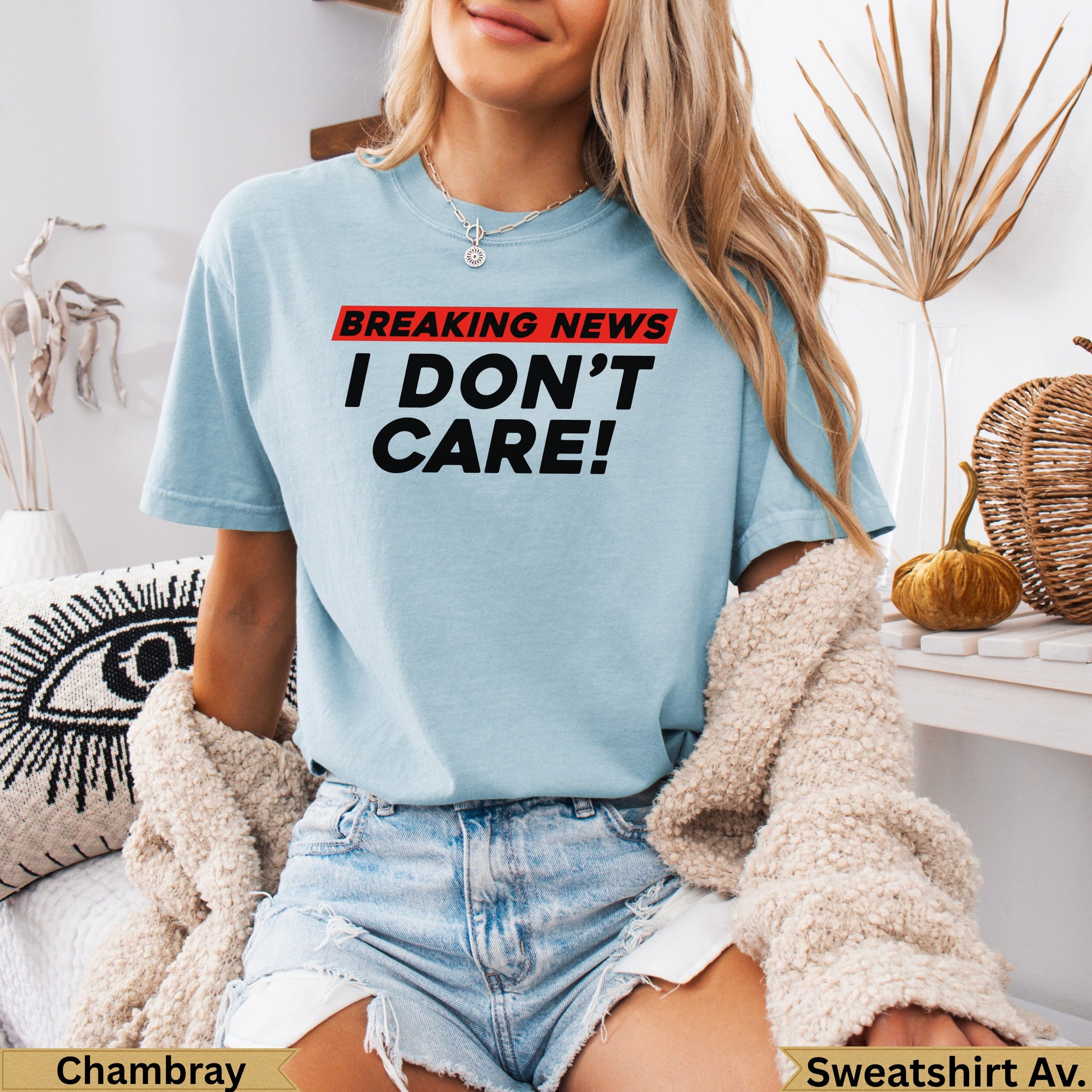 Light blue t-shirt with "BREAKING NEWS I DON'T CARE!" graphic.