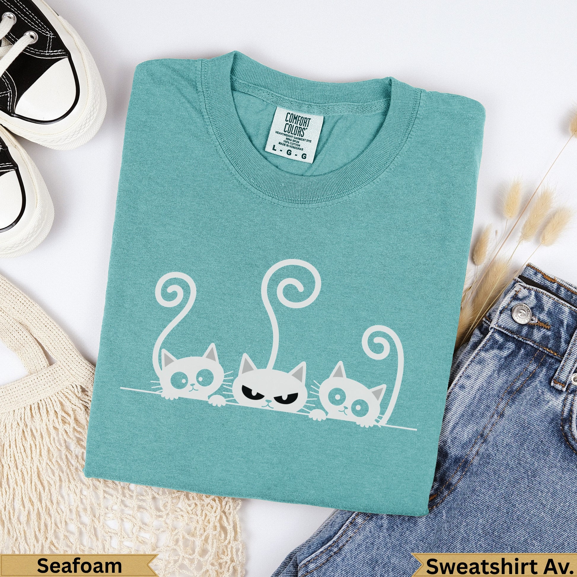 Teal t-shirt with three cartoon cats, "Seafoam" and "Sweatshirt Av." text.