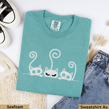 Teal t-shirt with three cartoon cats, "Seafoam" and "Sweatshirt Av." text.