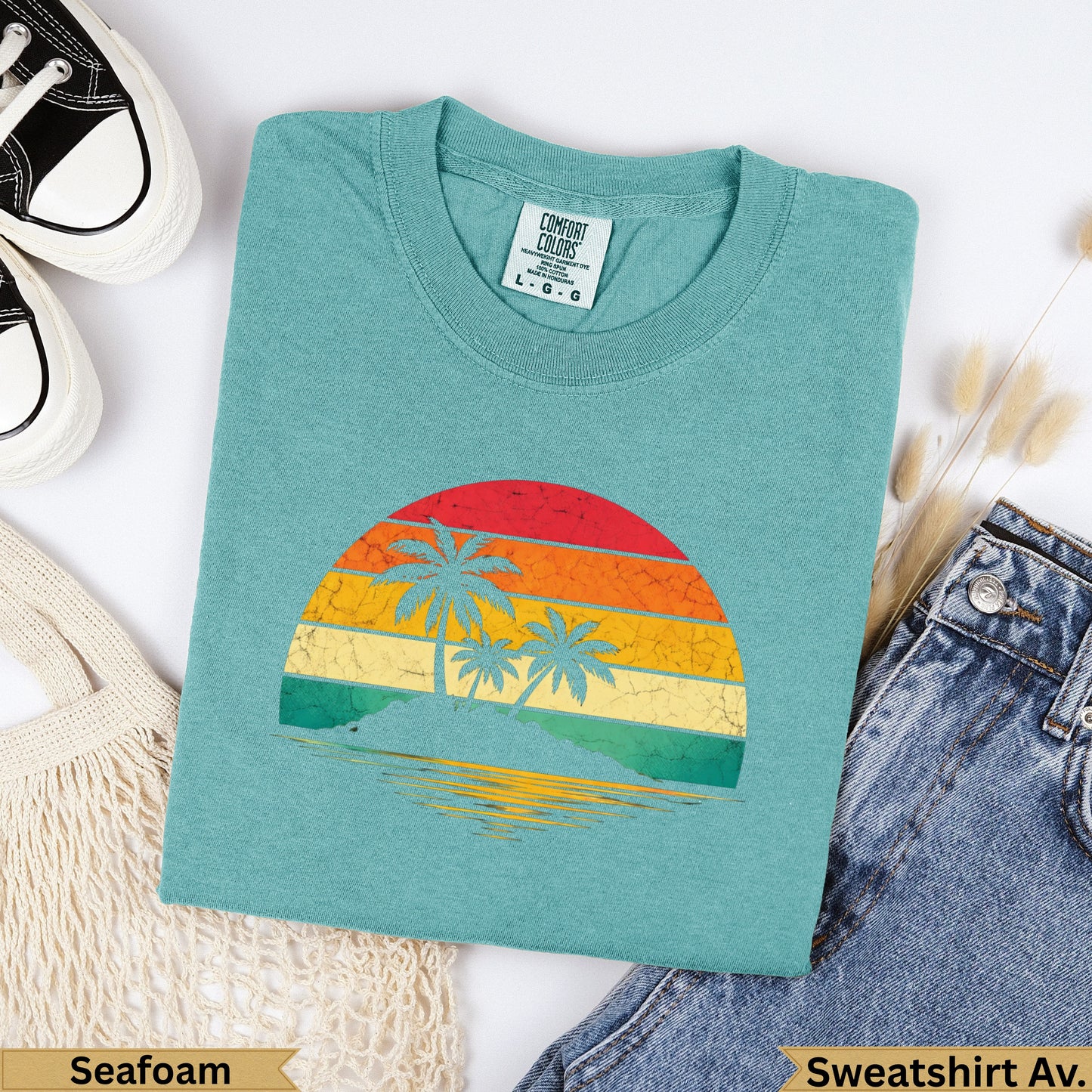 Teal Comfort Colors sweatshirt with retro sunset and palm trees graphic.