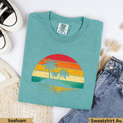 Teal Comfort Colors sweatshirt with retro sunset and palm trees graphic.